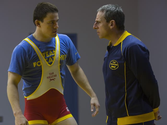 Tatum im Wrestling-Dress, Carell mit falscher Nase und grauen Haaren in Trainingsjacke. Tatum im Wrestling-Dress, Carell mit falscher Nase und grauen Haaren in Trainingsjacke.