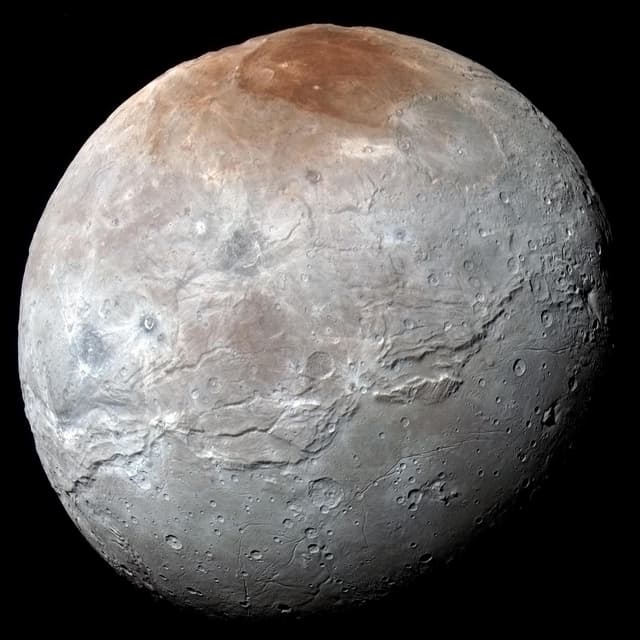 Der Mond Charon auf einem farblich überzeichneten Bild, um die Strukturen auf der Oberfläche zu betonen. Der Mond Charon auf einem farblich überzeichneten Bild, um die Strukturen auf der Oberfläche zu betonen.