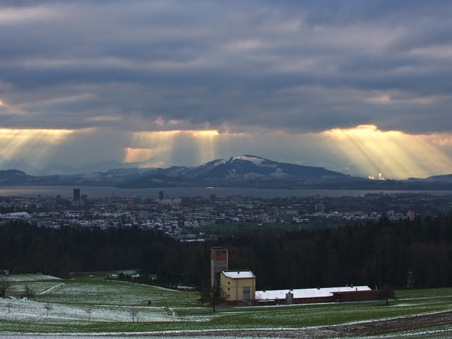 Sonnenstrahlen zwischen Wolken.