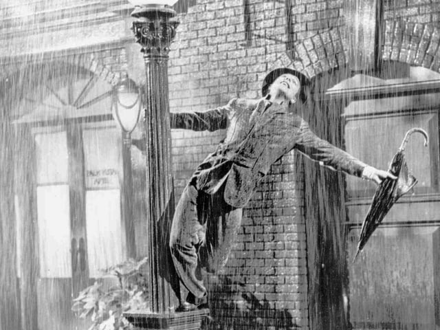 Purtret da Gene Kelly vid la laterna. Purtret da Gene Kelly vid la laterna.