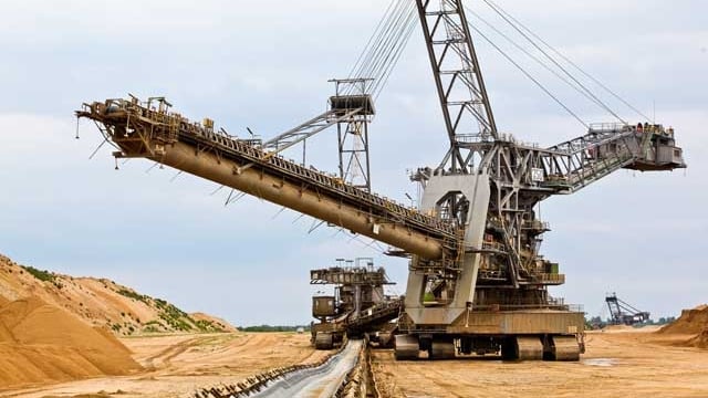 Ein riesiger Bagger beim Abbauen von Braunkohle. Ein riesiger Bagger beim Abbauen von Braunkohle.