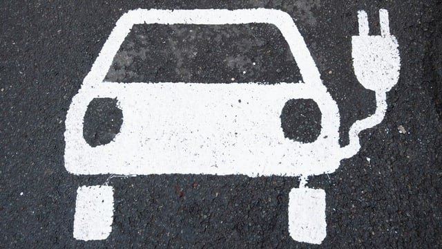Ein Symbol für ein Elektroauto markiert einen Parkplatz neben einer E-Ladesäule in Deutschland. Ein Symbol für ein Elektroauto markiert einen Parkplatz neben einer E-Ladesäule in Deutschland.