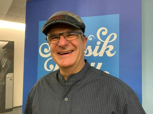 Mann mit Baskenmütze vor SRF Musikwelle-Logo Mann mit Baskenmütze vor SRF Musikwelle-Logo