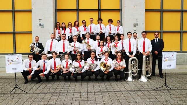 Musicistas e musicists cun lur dirigent da la Brass Band giuvanila dal Grischun. Musicistas e musicists cun lur dirigent da la Brass Band giuvanila dal Grischun.