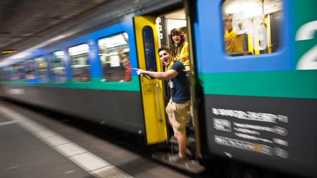 Fans stehen bei der Zugtüre. Fans stehen bei der Zugtüre.