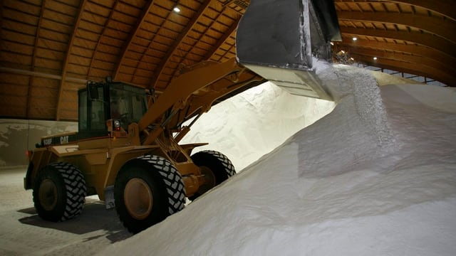 Bagger schaufelt Streusalz in Rheinsaline Bagger schaufelt Streusalz in Rheinsaline
