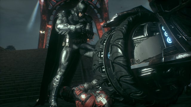 Indem er ihm mit dem Batmobil über den Kopf fährt. Indem er ihm mit dem Batmobil über den Kopf fährt.