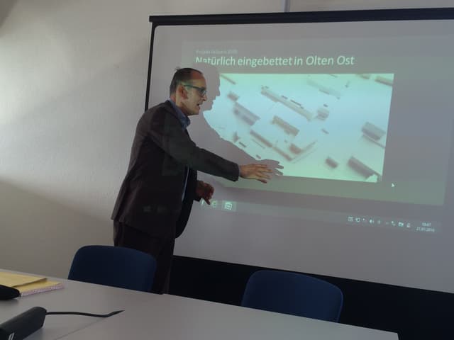 Mann präsentiert vor Leinwand das Projekt Mann präsentiert vor Leinwand das Projekt