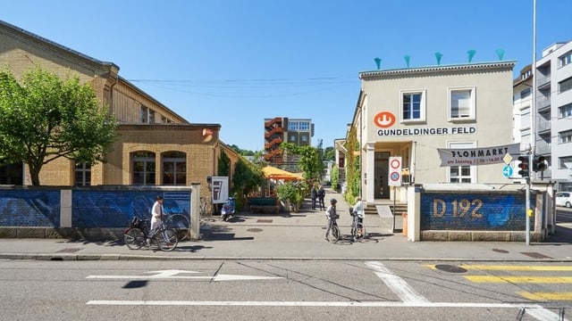 eine Strasse und ein Haus im Hintergrund mit Fussgängern eine Strasse und ein Haus im Hintergrund mit Fussgängern