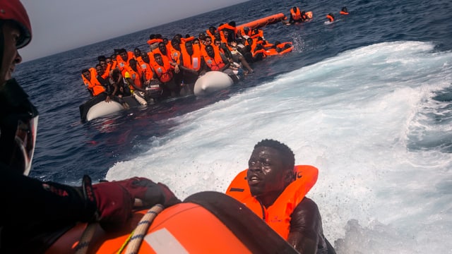 Ein Mann versucht, vor der libyschen Küste das Schiff einer spanischen NGO zu erreichen. Ein Mann versucht, vor der libyschen Küste das Schiff einer spanischen NGO zu erreichen.