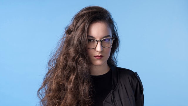 Eine junge Frau vor blauem Hintergrund. Eine junge Frau vor blauem Hintergrund.