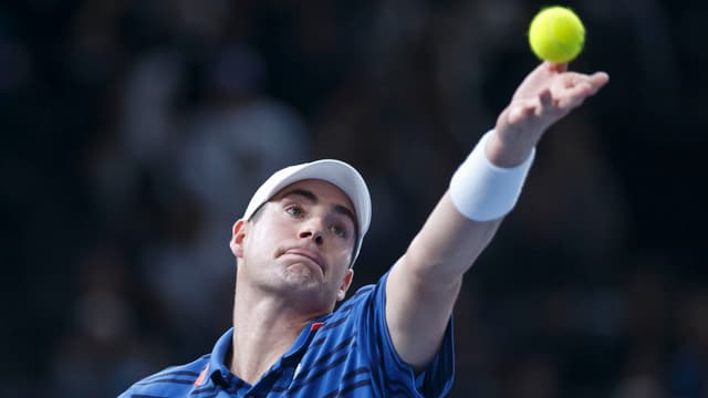 John Isner wirft den Ball zum Aufschlag auf. John Isner wirft den Ball zum Aufschlag auf.