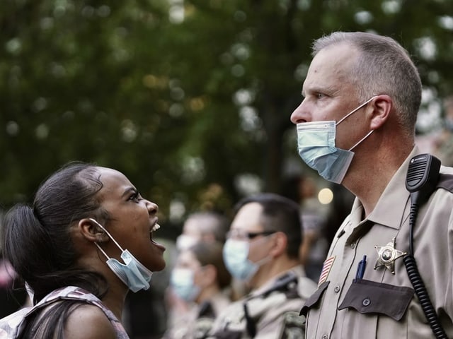 Minnesota protester expresses anger against a police officer.