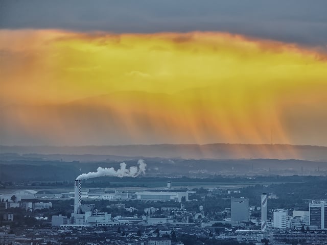 Schornsteine im Vordergrund, Regenschauer im Hintergrund.