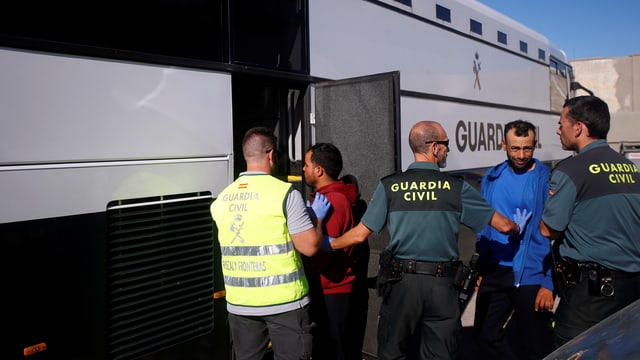 Migranten steigen in einen Bus Migranten steigen in einen Bus