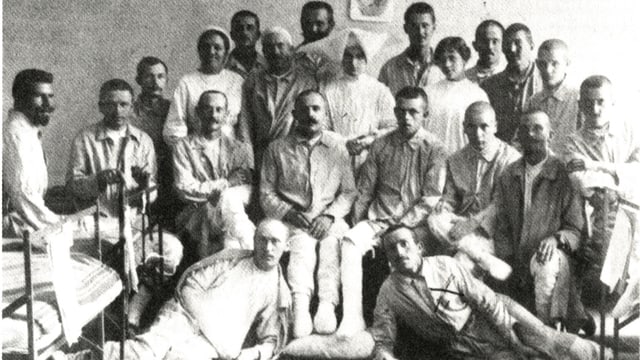Man sieht eine Gruppe von Soldaten im Kriegsspital. Sie posieren mit den Krankenschwestern. Man sieht eine Gruppe von Soldaten im Kriegsspital. Sie posieren mit den Krankenschwestern.