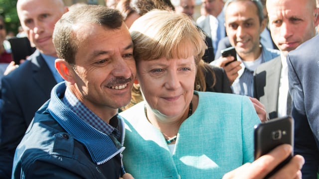 Merkel posiert mit Flüchtling für ein Selfie. Merkel posiert mit Flüchtling für ein Selfie.