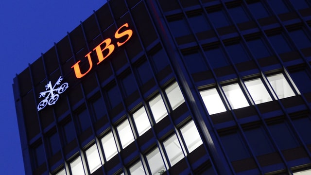 Leuchtendes UBS-Logo an einem Gebäude. Leuchtendes UBS-Logo an einem Gebäude.