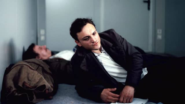 Franz Rogowski als sinnierender Flüchtlich auf einem Bett. Franz Rogowski als sinnierender Flüchtlich auf einem Bett.