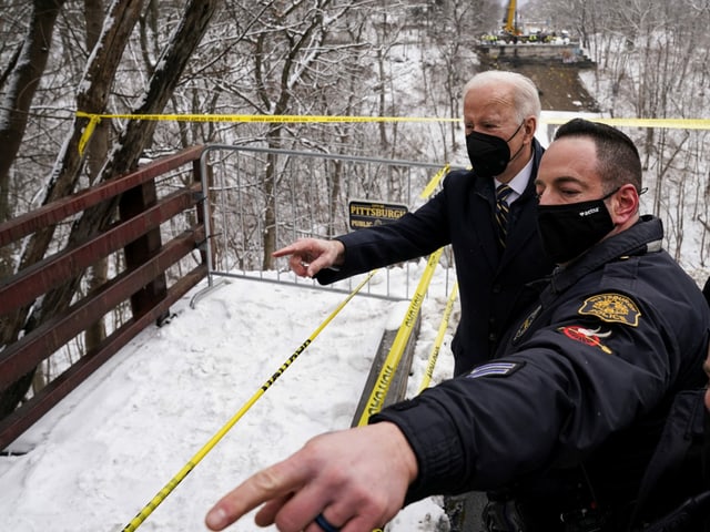 Biden and a person from the emergency services inspect the scene of the accident.