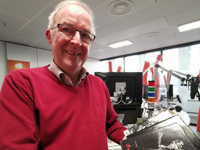 Ein älterer Mann mit Brille und rotem Pullover. Ein älterer Mann mit Brille und rotem Pullover.