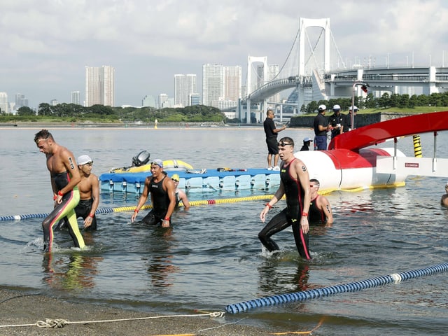 Swimmers come out of the water in Tokyo Swimmers come out of the water in Tokyo