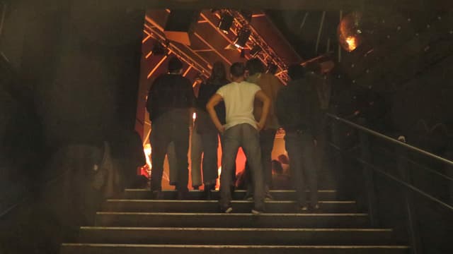 Leute stehen auf einer Treppe in einem Klub Leute stehen auf einer Treppe in einem Klub