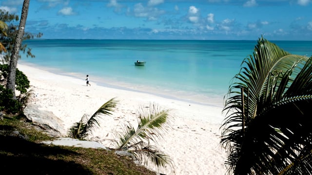 Ein weisser Strand, an dem ein kleiner Junge entlangläuft. Ein weisser Strand, an dem ein kleiner Junge entlangläuft.