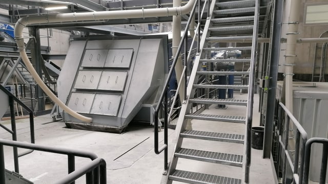 Maschine und Treppe in einer grossen Halle Maschine und Treppe in einer grossen Halle