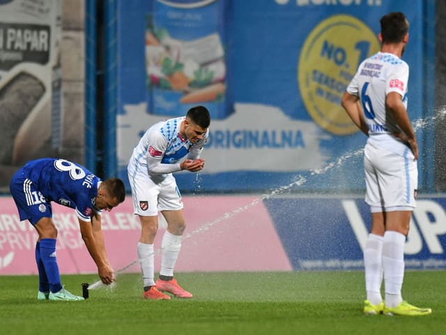 In der höchsten kroatischen Spielklasse gönnen sich Arijan Brkovic (l.) und Vinko Petkovic einen Schluck aus dem Rasensprenger. Genutzt hat es nur letzterem: Aufsteiger Hrvatski Dragovoljac feiert gegen Slaven Belupo im 7. Spiel den 1. Saisonsieg.