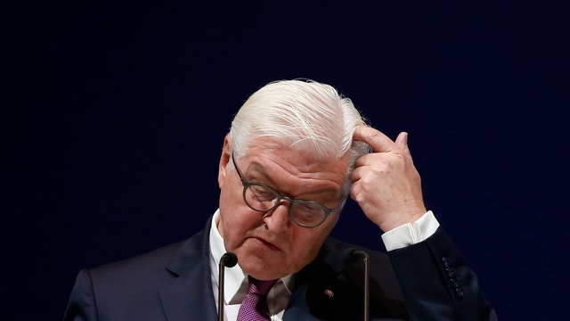 Steinmeier spricht vor schwarzem Hintergrund in ein Mikrofon, er kratzt sich am Kopf. Steinmeier spricht vor schwarzem Hintergrund in ein Mikrofon, er kratzt sich am Kopf.