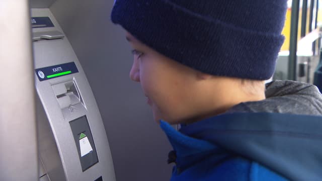Kind am Geldautomat