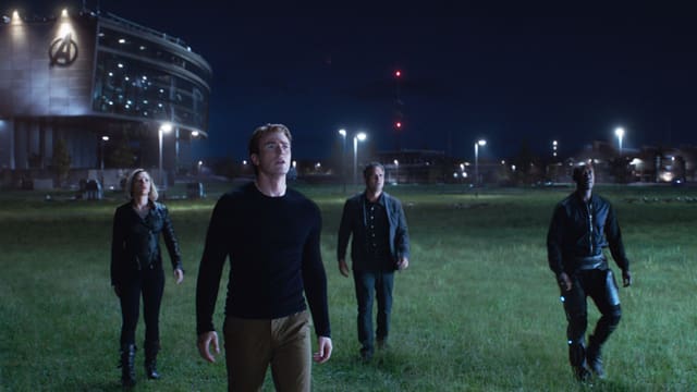 Film scene: A woman and three men stand at night on a meadow and look upwards. Film scene: A woman and three men stand at night on a meadow and look upwards.