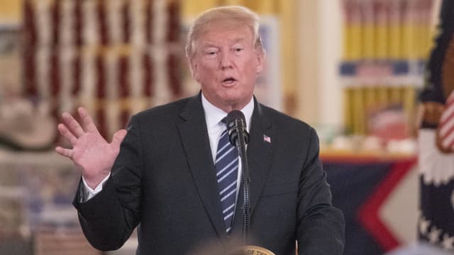 Trump spricht in ein Mikrofon. Trump spricht in ein Mikrofon.