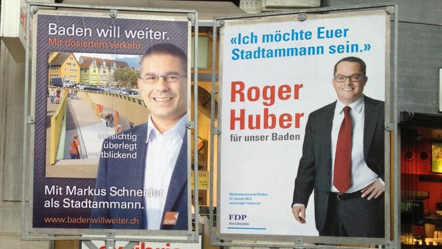 Wahlplakate von Markus Schneider und von Roger Huber.