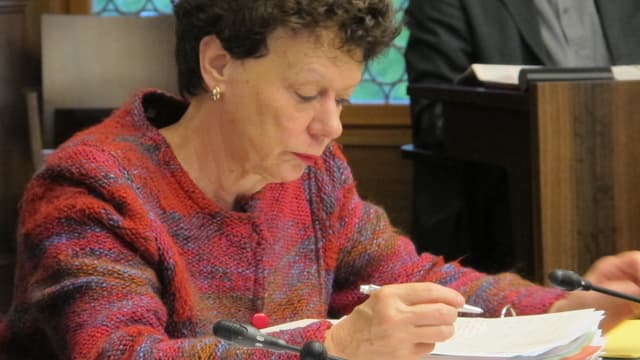 Esther Gassler sitzt im Raatssaal und blick konzentriert auf ihre Unterlagen. Esther Gassler sitzt im Raatssaal und blick konzentriert auf ihre Unterlagen.