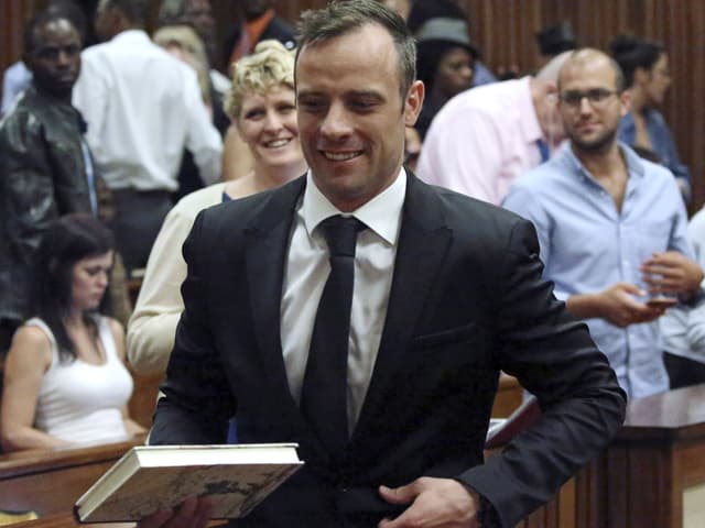 Lächelnder Oscar Pistorius schreitet durch Gerichtssaal