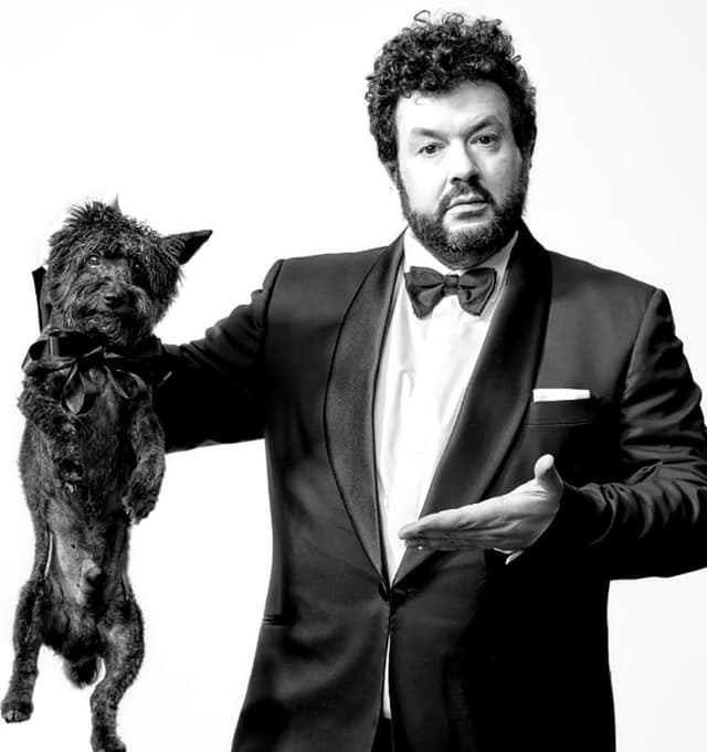 Ein Mann im Smoking mit einem Hund am Schlafittchen. Ein Mann im Smoking mit einem Hund am Schlafittchen.