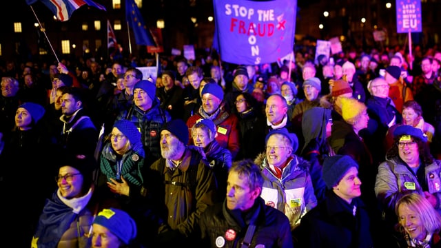 People are standing together during the night.