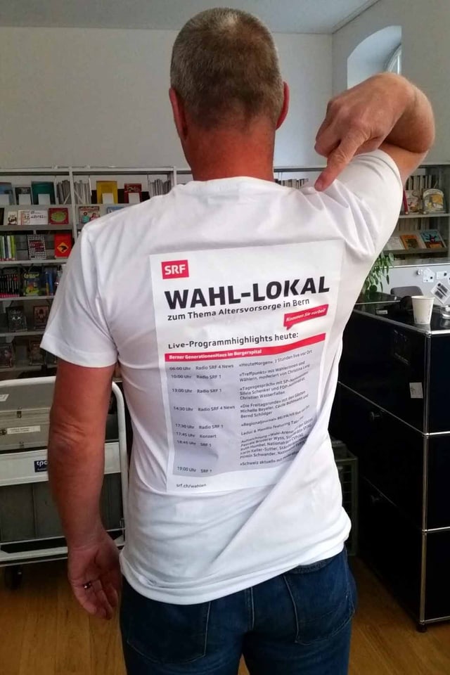Eine Person mit einem T-Shirt auf dem das Programm abgedruckt ist.