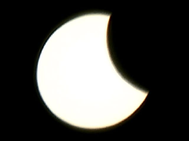 Mond schiebt sich von rechts über die Sonne.