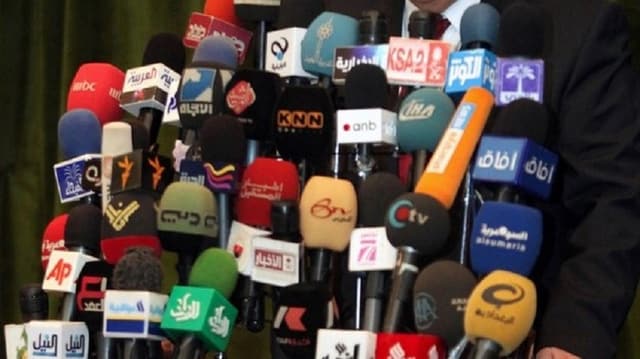 Viele bunte Mikrophone vor Rednerpult Viele bunte Mikrophone vor Rednerpult