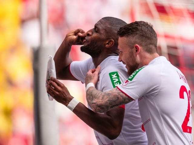 Anthony Modeste jubelt nach seinem Führungstreffer für den 1. FC Köln gegen Arminia Bielefeld mit seiner eigenen Kaffee-Röstung und hält die Verpackung in die Kamera.