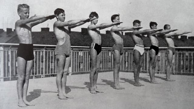 Schwarzweiss-Aufnahme von Jungen in Badehosen bei Trockenübungen. Schwarzweiss-Aufnahme von Jungen in Badehosen bei Trockenübungen.