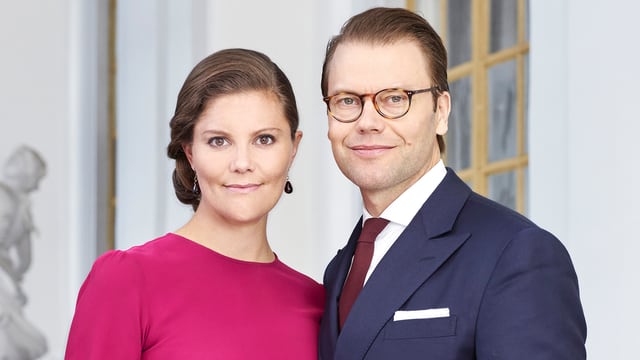 Kronprinzessin Victoria im fuchsiafarbenen Kleid, neben ihrem Mann Prinz Daniel in einem blauen Anzug. Kronprinzessin Victoria im fuchsiafarbenen Kleid, neben ihrem Mann Prinz Daniel in einem blauen Anzug.