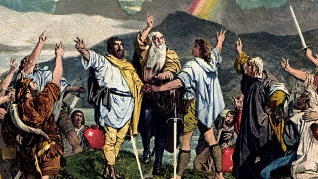 Ein Gemälde: Bärtige Männer, um ein Schwert versammelt, strecken ihre rechte Hand dem Himmel empor, drei Finger zum Schwur gespreizt. Ein Gemälde: Bärtige Männer, um ein Schwert versammelt, strecken ihre rechte Hand dem Himmel empor, drei Finger zum Schwur gespreizt.