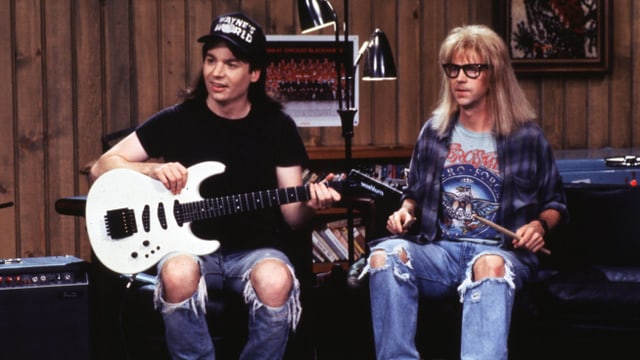 Wayne und Garth mit Gitarre und Schlagzeugstöcken. Wayne und Garth mit Gitarre und Schlagzeugstöcken.