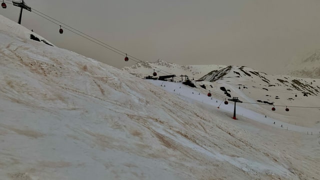 White slopes surrounded by red mountain slopes.