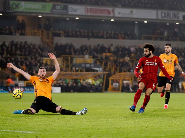 Wolverhamptons Matt Doherty wirft sich in einen Abschluss von Mohamed Salah. Wolverhamptons Matt Doherty wirft sich in einen Abschluss von Mohamed Salah.