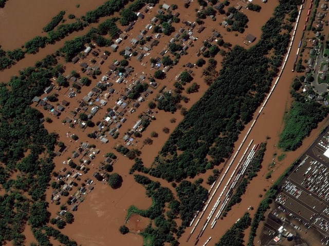 In Manville, New Jersey, a railroad line and houses are flooded after torrential rains.